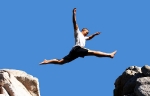 boy jumping over the mountains